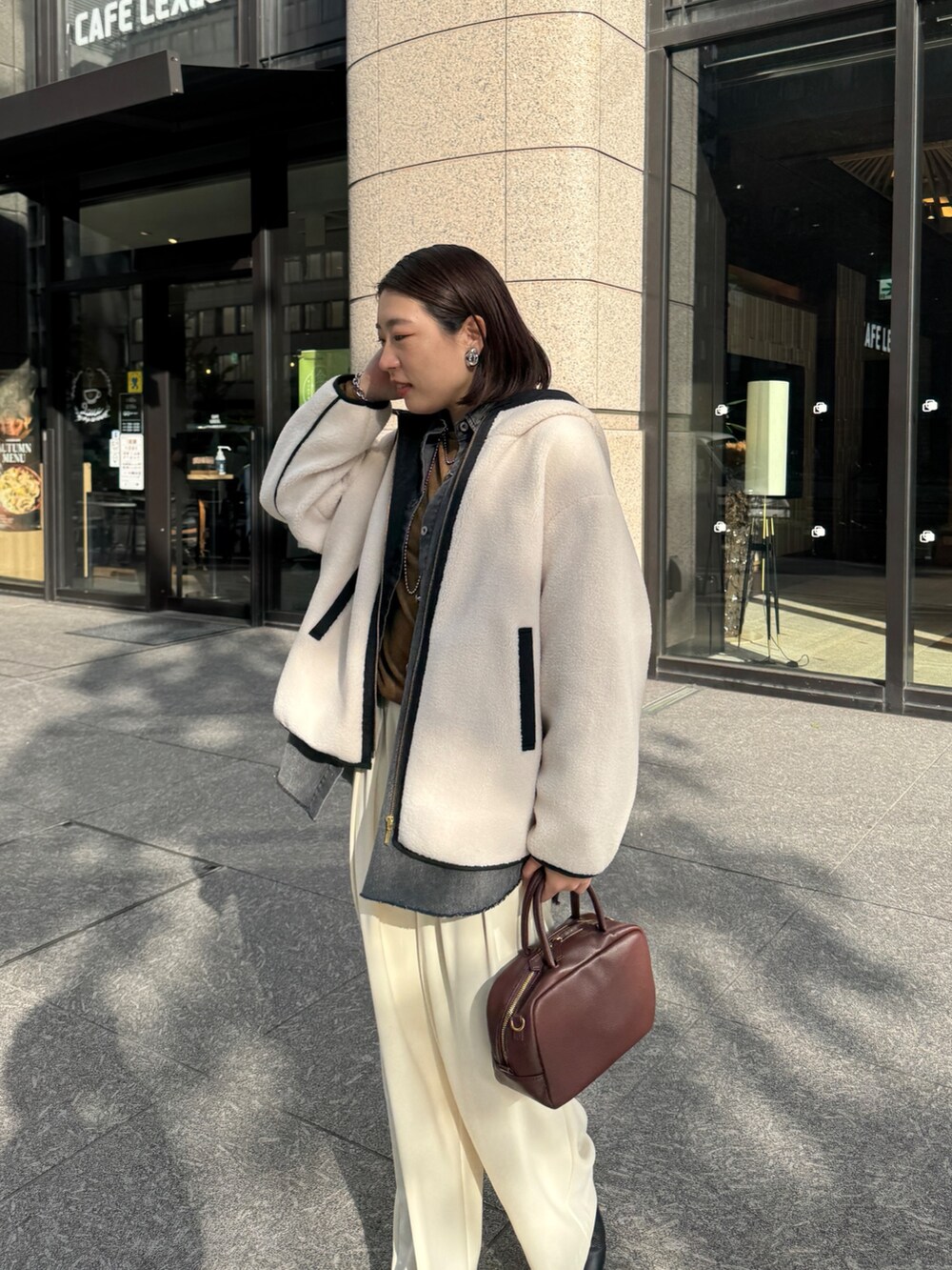 ホワイト系のその他アウター、ブルー系のシャツ/ブラウス、ブラウン系のTシャツ/カットソーを着用したレディースの秋コーディネートの3枚目の写真