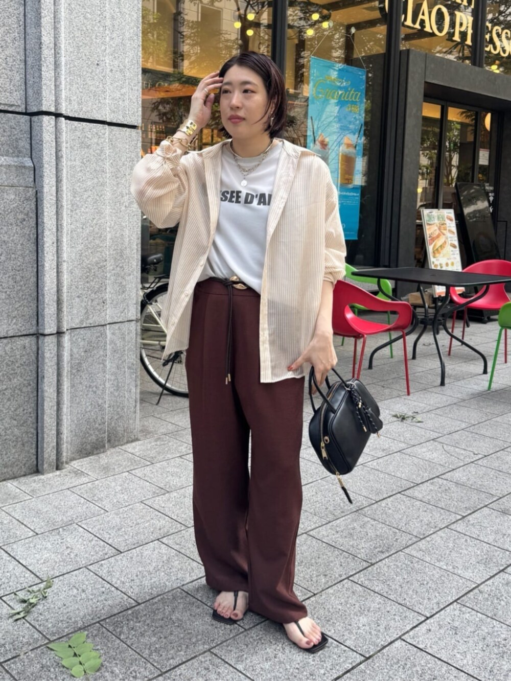 グレー系のシャツ/ブラウス、ブラック系のショルダーバッグ、レッド系のその他パンツを着用したレディースの夏コーディネートの4枚目の写真