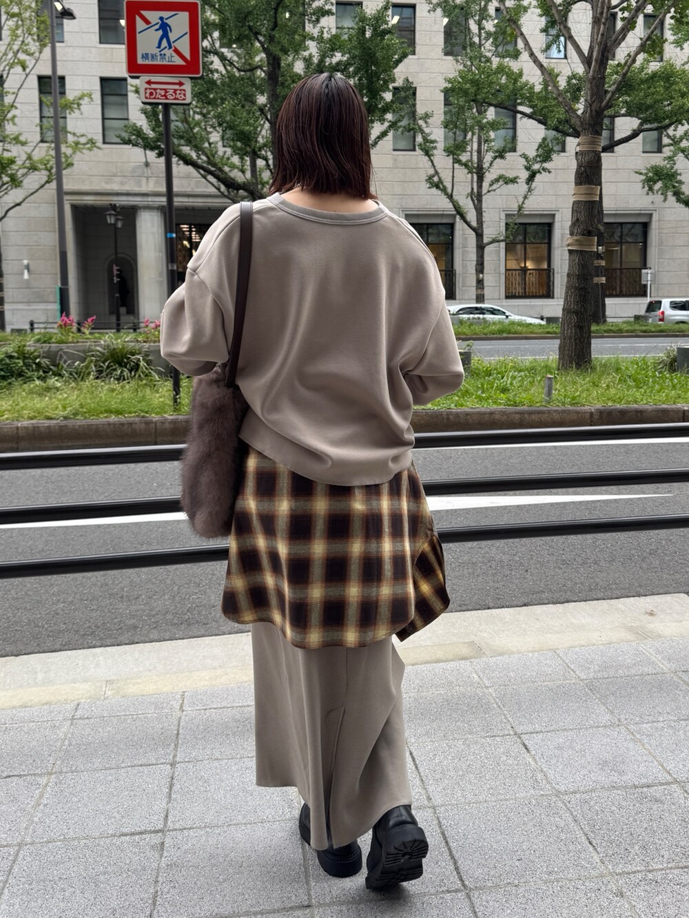 ベージュ系のTシャツ/カットソー、ベージュ系のスカート、ブラウン系のショルダーバッグを着用したレディースの秋コーディネートの4枚目の写真