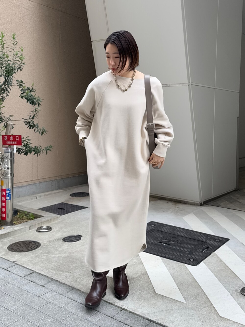 ベージュ系のワンピース、ブラウン系のその他アウター、ブラウン系のブーツを着用したレディースの冬コーディネートの5枚目の写真