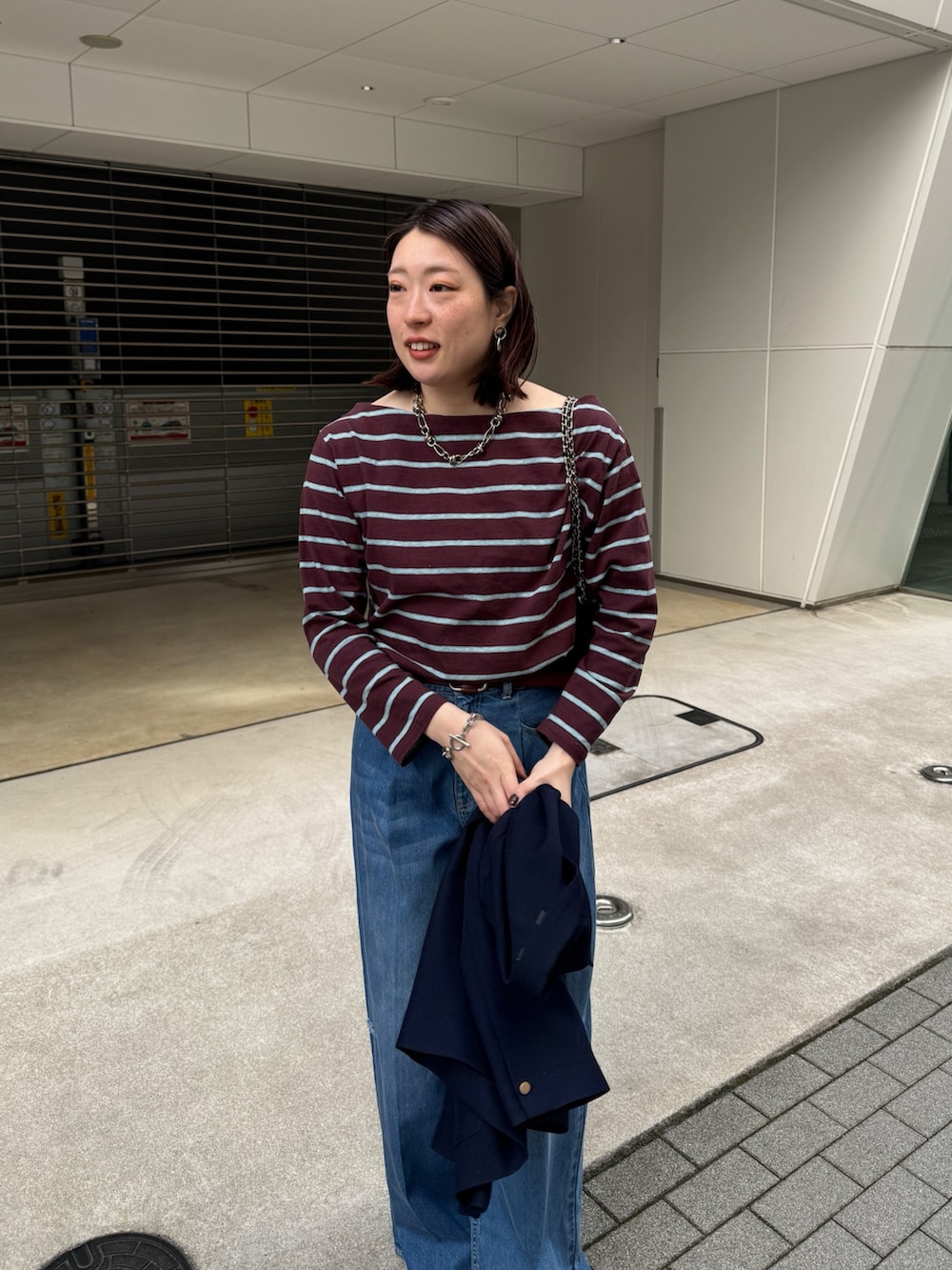 ブルー系のデニムパンツ、ブルー系のテーラードジャケット、ブラウン系のTシャツ/カットソーを着用したレディースの春コーディネートの7枚目の写真