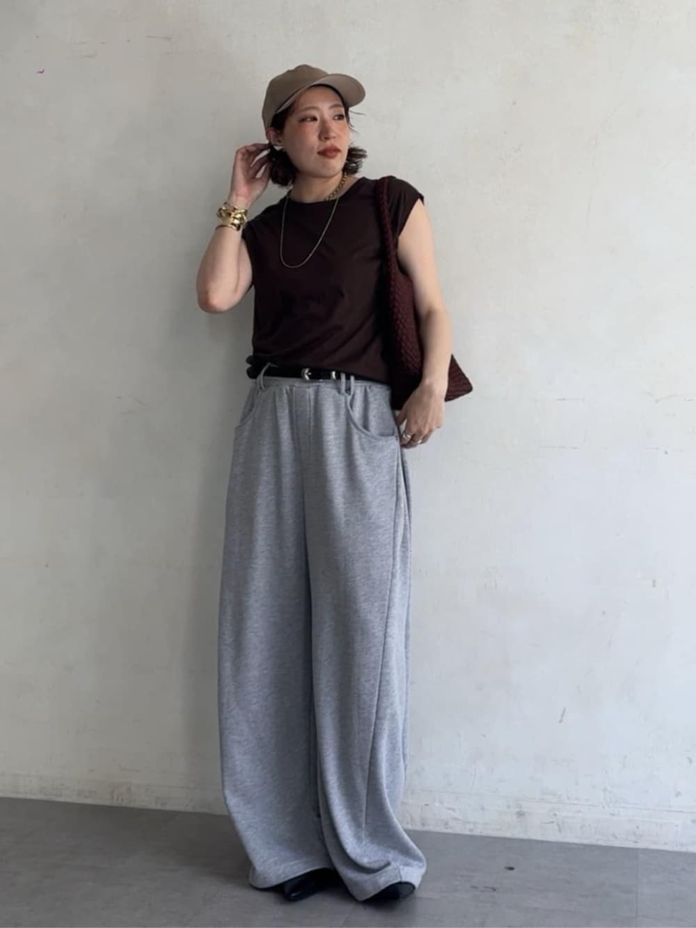 ブラウン系のTシャツ/カットソー、グレー系のスウェットパンツ、ブラウン系のトートバッグを着用したレディースの夏コーディネートの2枚目の写真