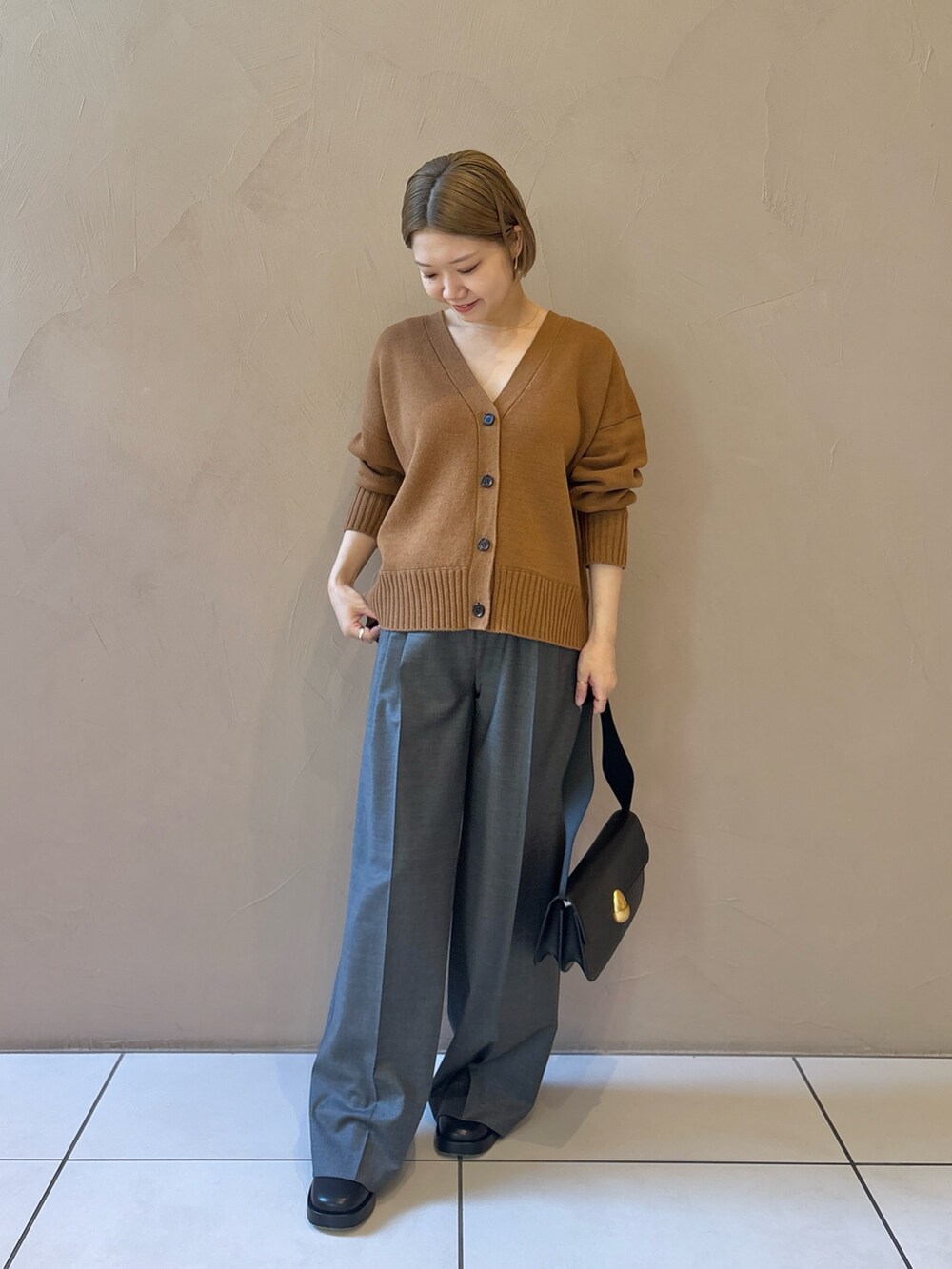 グレー系のスラックスを着用したレディースの秋コーディネートの6枚目の写真