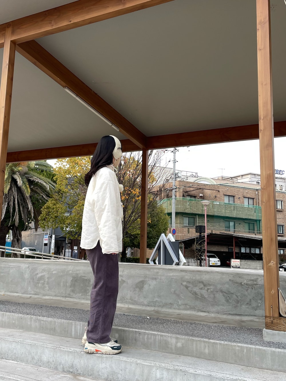 ホワイト系のその他アウター、ホワイト系のその他トップス、ブラウン系のショルダーバッグを着用したレディースの冬コーディネートの4枚目の写真