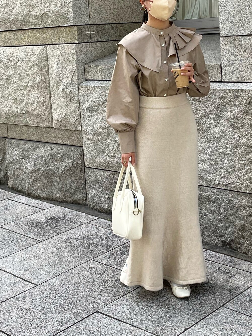 ベージュ系のスカート、ホワイト系のボストンバッグ、ブラウン系のシャツ/ブラウスを着用したレディースの秋コーディネートの2枚目の写真