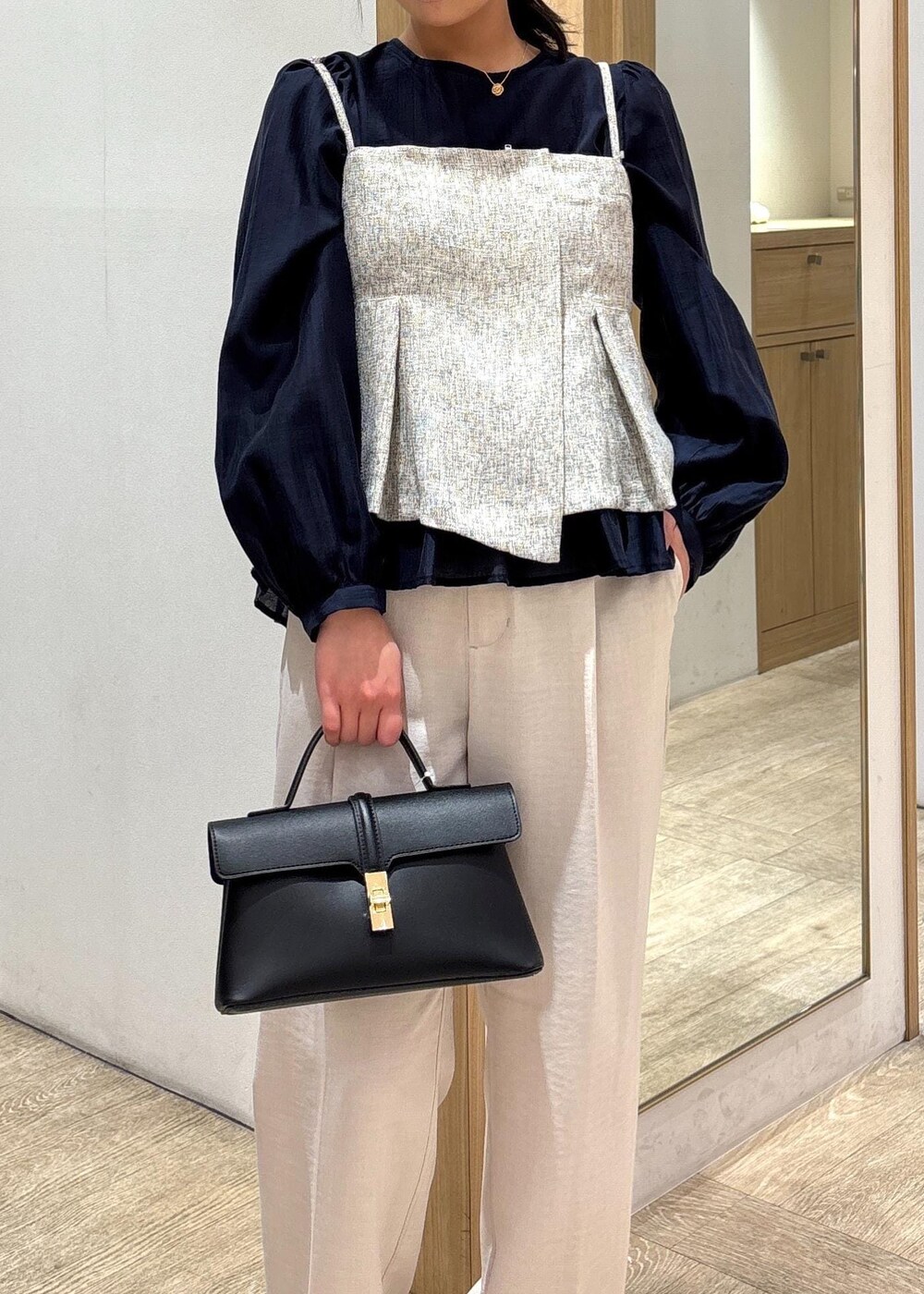 ブラック系のショルダーバッグ、ブルー系のシャツ/ブラウス、シルバー系のパンプスを着用したレディースの春コーディネートの6枚目の写真