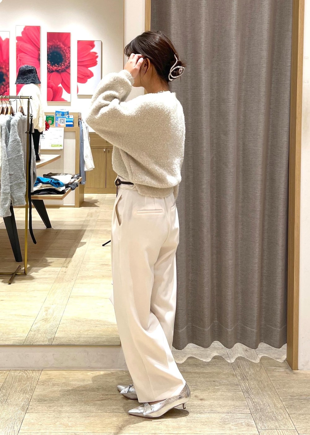 シルバー系のパンプス、ベージュ系のニット/セーター、ホワイト系のスラックスを着用したレディースの冬コーディネートの4枚目の写真