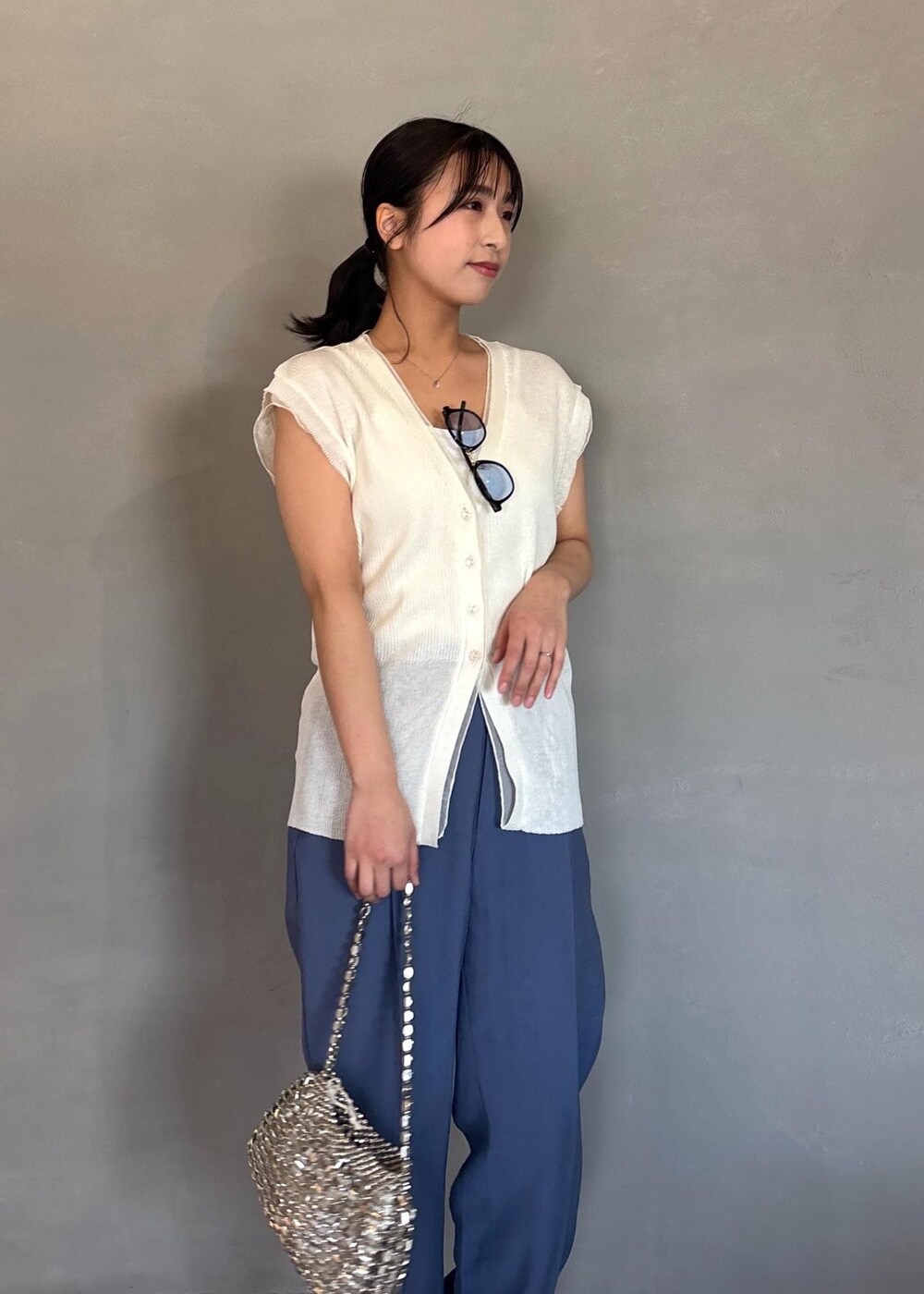 シルバー系のパンプス、ブルー系のその他パンツ、ホワイト系のベストを着用したレディースの春コーディネートの5枚目の写真