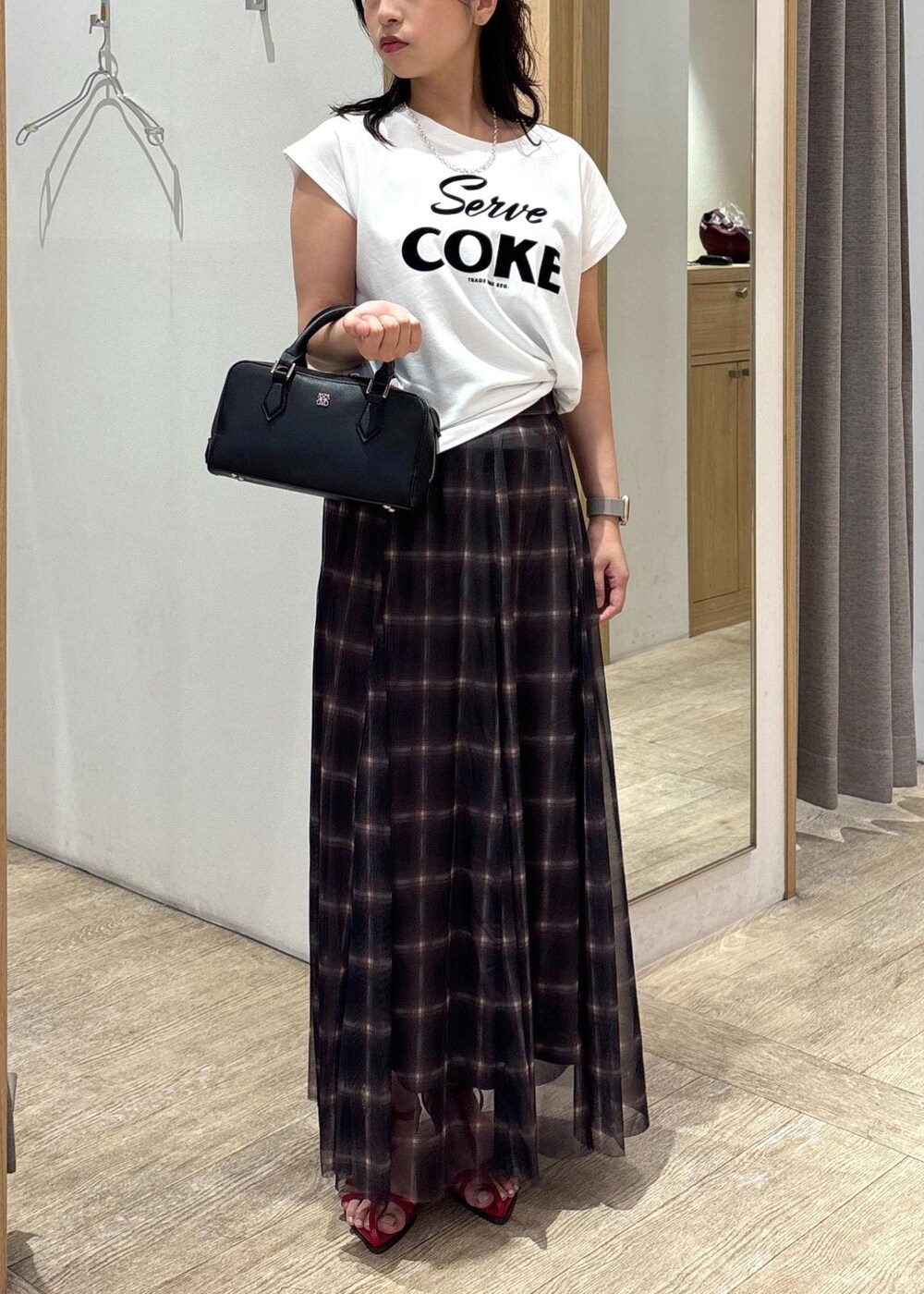 レッド系のサンダル、ブラック系のショルダーバッグ、ブラウン系のスカートを着用したレディースの夏コーディネートの9枚目の写真