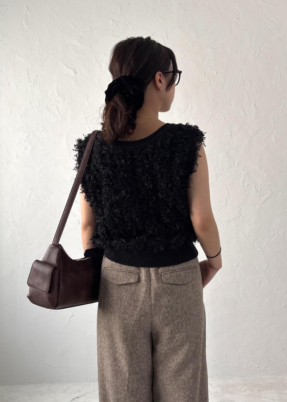 ブラック系のパンプス、ブラック系のベスト、ブラウン系のショルダーバッグを着用したレディースの夏コーディネートの7枚目の写真