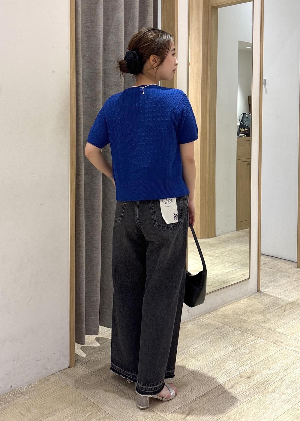 ブラック系のショルダーバッグ、ブラック系のデニムパンツ、ホワイト系のTシャツ/カットソーを着用したレディースの春コーディネートの4枚目の写真