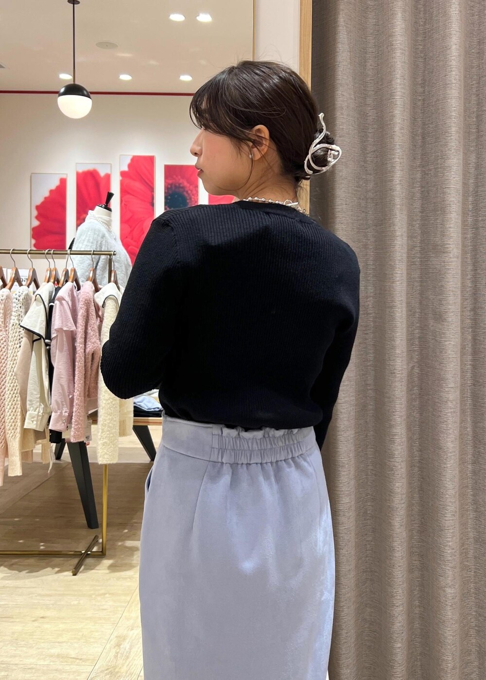 シルバー系のブーツ、ブルー系のスカート、ブラック系のニット/セーターを着用したレディースの冬コーディネートの9枚目の写真
