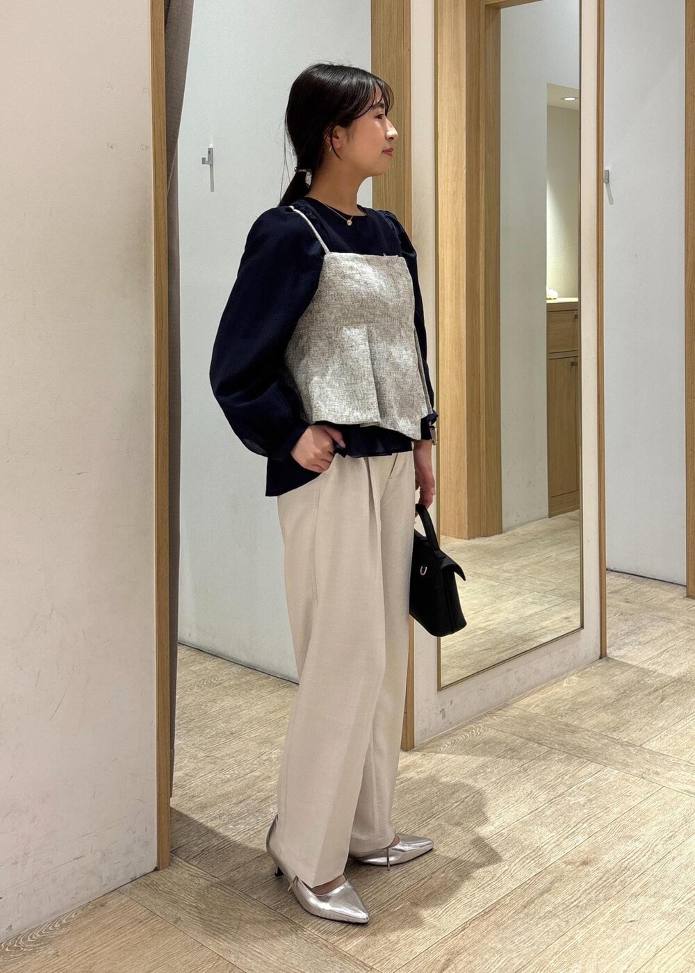 ブラック系のショルダーバッグ、ブルー系のシャツ/ブラウス、シルバー系のパンプスを着用したレディースの春コーディネートの3枚目の写真