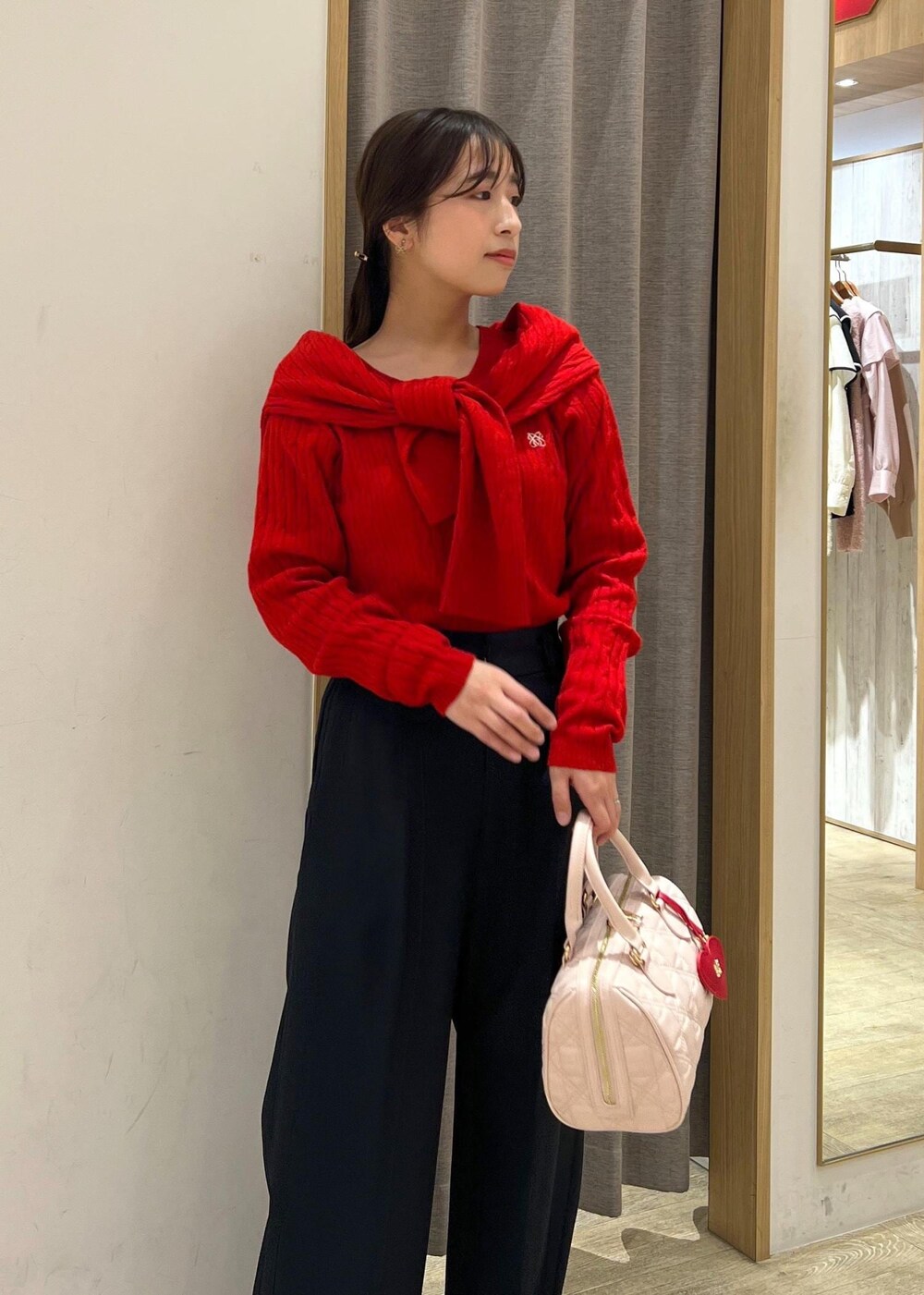 シルバー系のパンプス、レッド系のカーディガン/ボレロ、レッド系のニット/セーターを着用したレディースの冬コーディネートの5枚目の写真