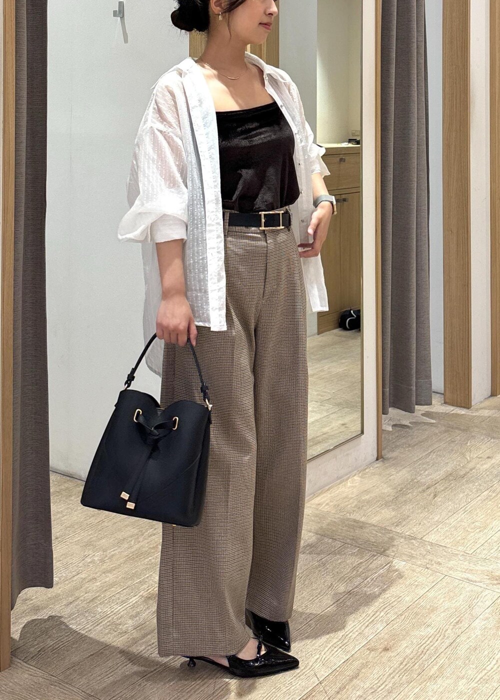 ブラック系のショルダーバッグ、ブラック系のパンプス、ホワイト系のシャツ/ブラウスを着用したレディースの秋コーディネートの9枚目の写真