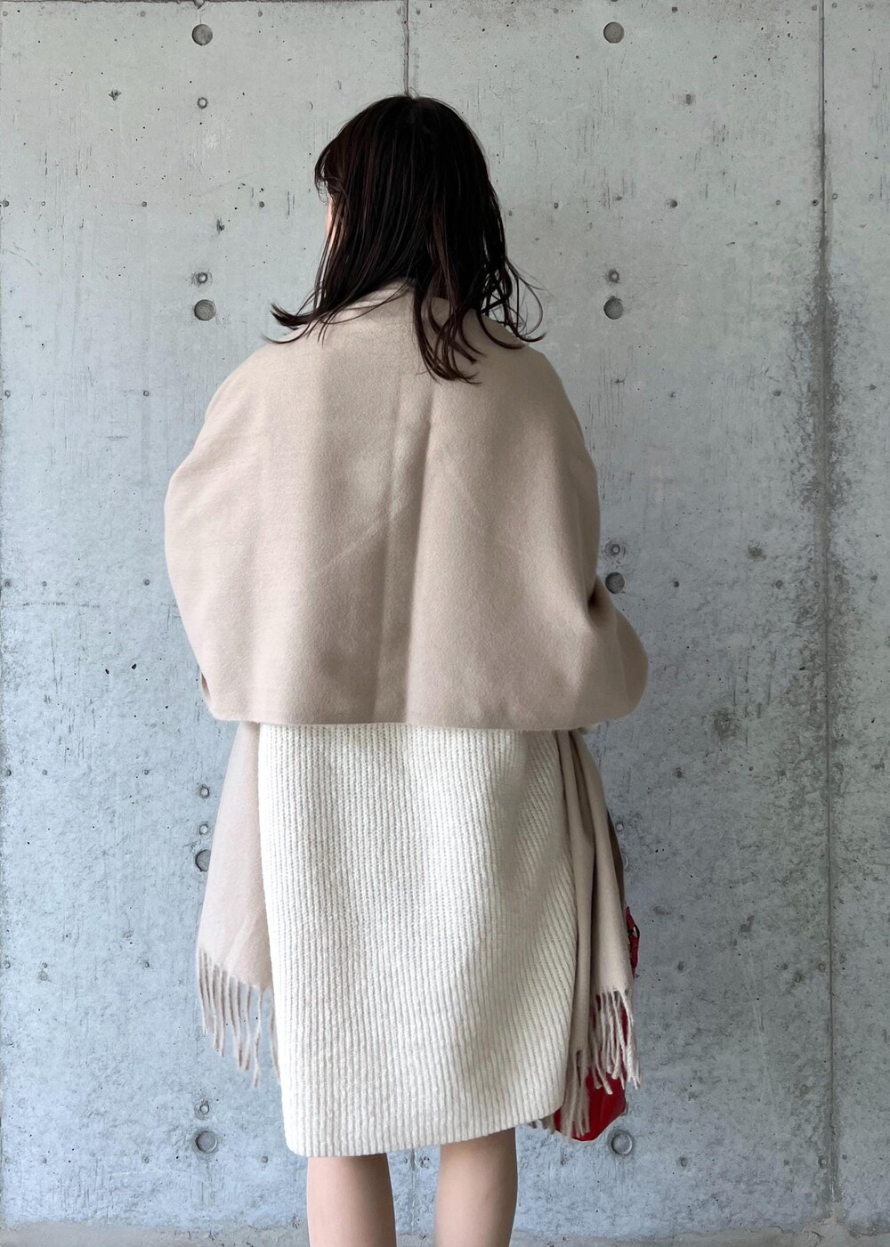 ブラウン系のブーツ、レッド系のショルダーバッグ、ホワイト系のワンピースを着用したレディースの冬コーディネートの9枚目の写真