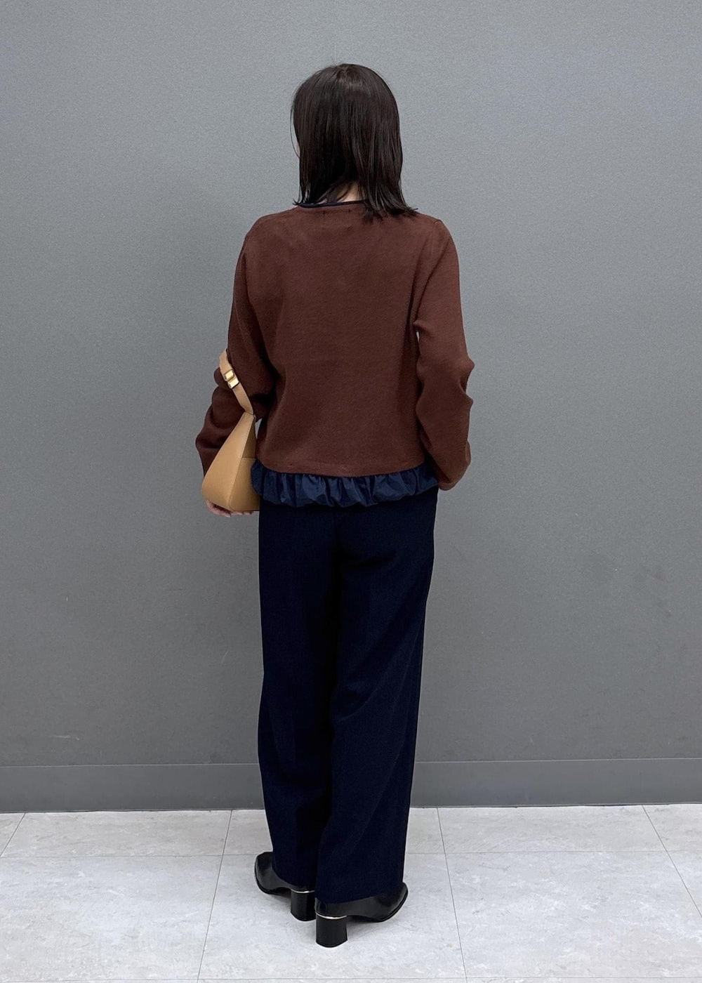 イエロー系のショルダーバッグ、ブルー系のその他パンツ、ブラック系のブーツを着用したレディースの秋コーディネートの3枚目の写真