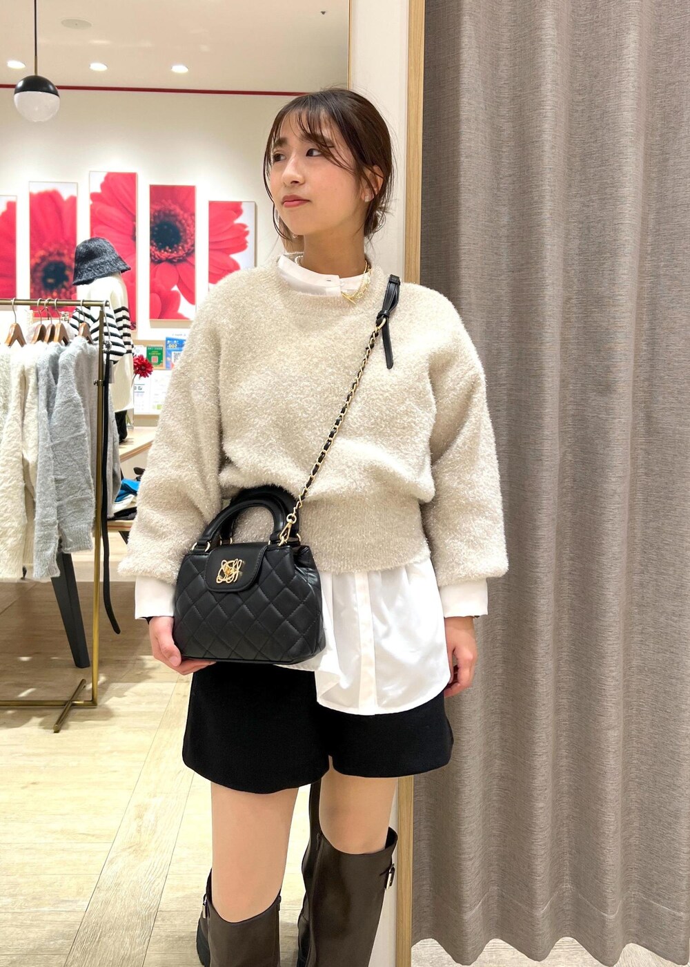 ブラウン系のブーツ、ホワイト系のシャツ/ブラウス、ベージュ系のニット/セーターを着用したレディースの冬コーディネートの6枚目の写真