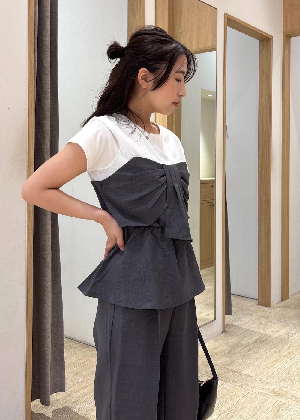 ブラック系のサンダル、グレー系のTシャツ/カットソー、グレー系のスラックスを着用したレディースの夏コーディネートの7枚目の写真