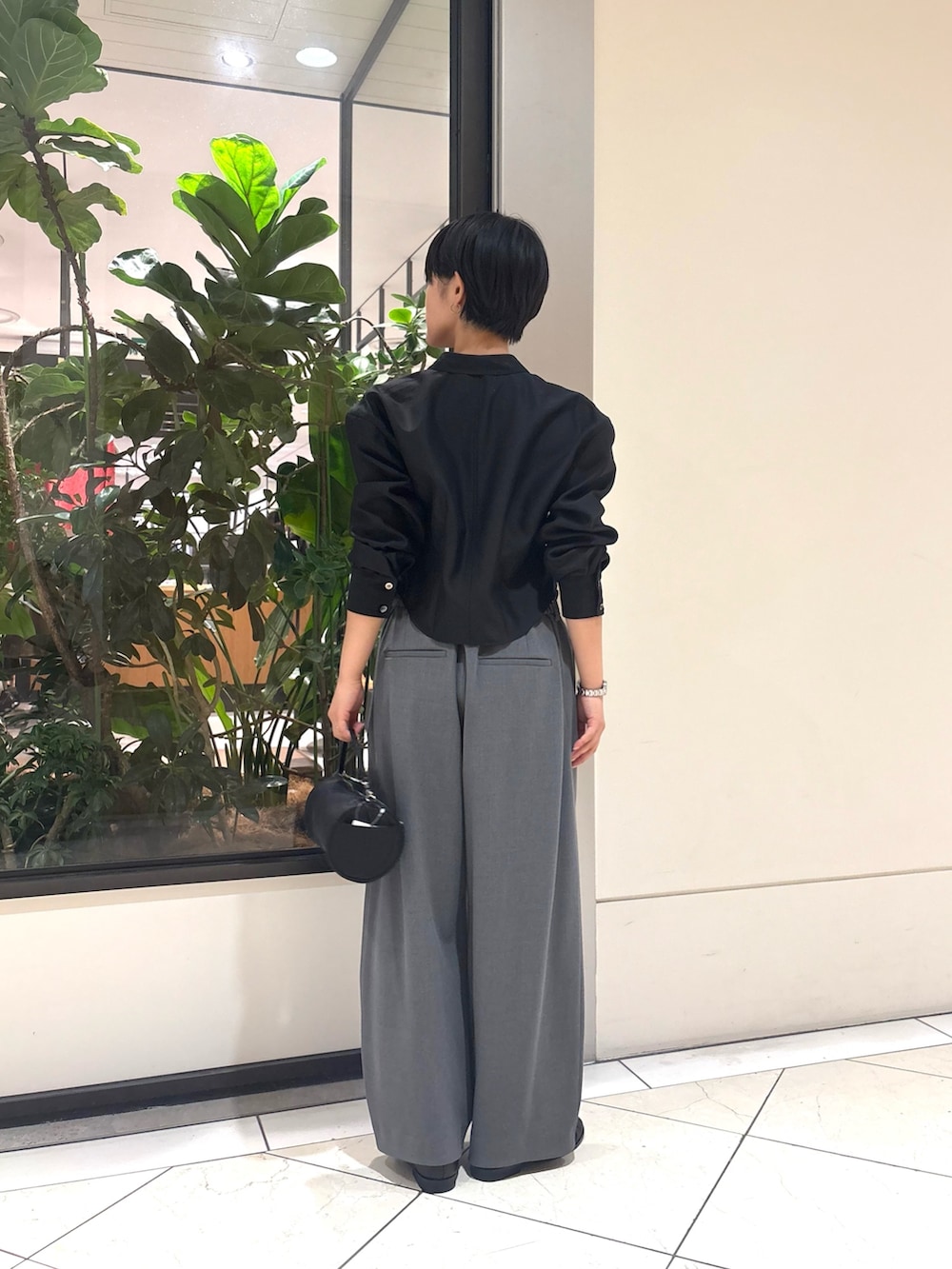 ブラック系のシャツ/ブラウス、グレー系のその他パンツ、ブラック系のローファーを着用したレディースの秋コーディネートの3枚目の写真