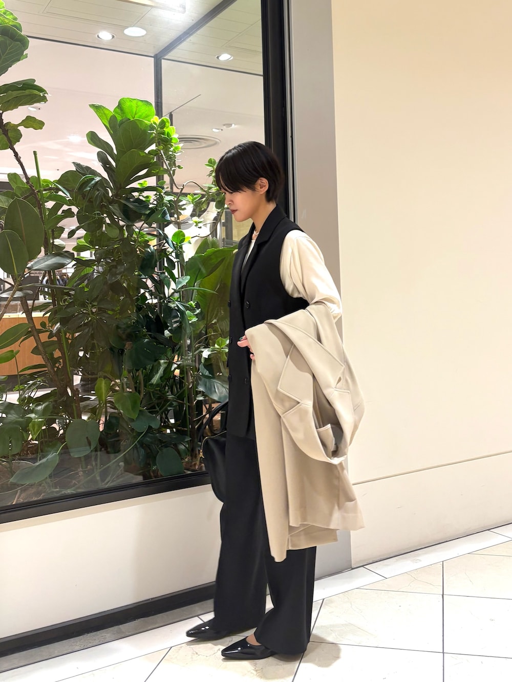 ブラック系のその他パンツ、ブラック系のその他アウター、ブラック系のショルダーバッグを着用したレディースの冬コーディネートの4枚目の写真