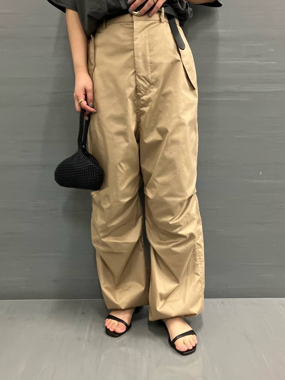 グレー系のTシャツ/カットソー、ベージュ系のその他パンツ、ブラック系のハンドバッグを着用したレディースの夏コーディネートの4枚目の写真