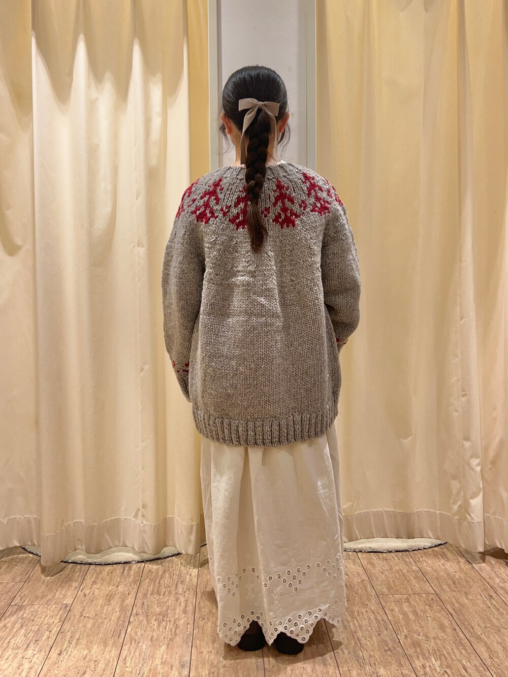 ホワイト系のワンピース、グレー系のカーディガン/ボレロを着用したレディースの秋コーディネートの3枚目の写真