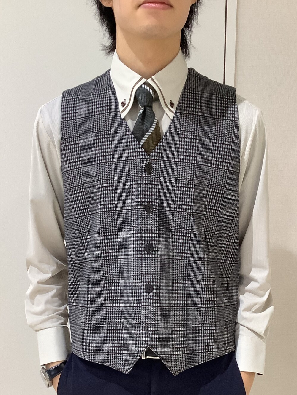 ブラウン系のビジネスシャツ、ブラウン系のベストを着用したメンズの秋コーディネートの2枚目の写真