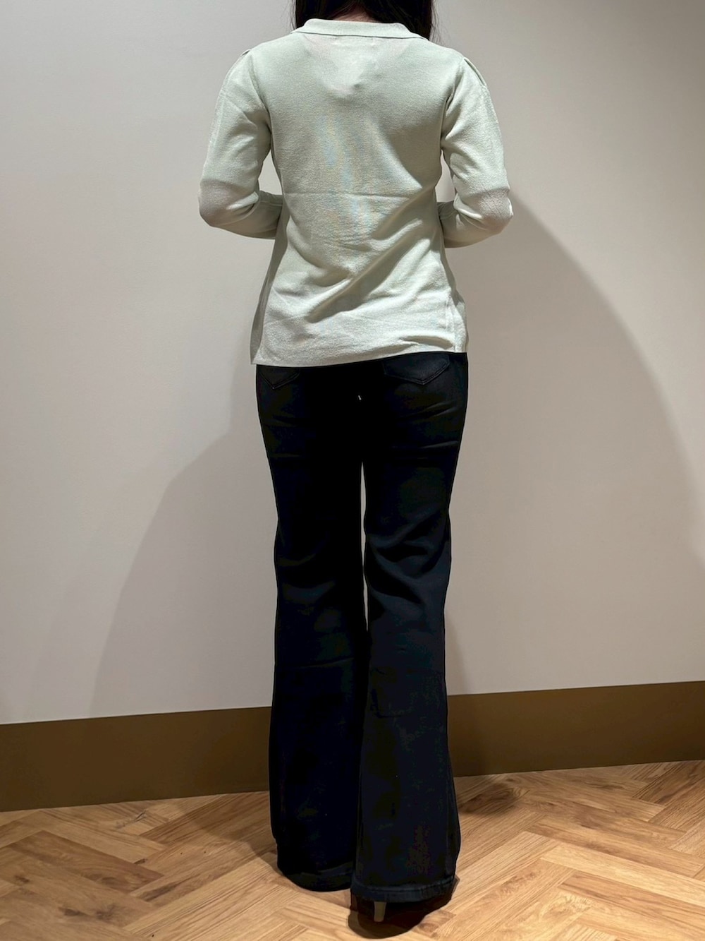 グリーン系のニット/セーター、ブラック系のその他パンツを着用したレディースの春コーディネートの3枚目の写真