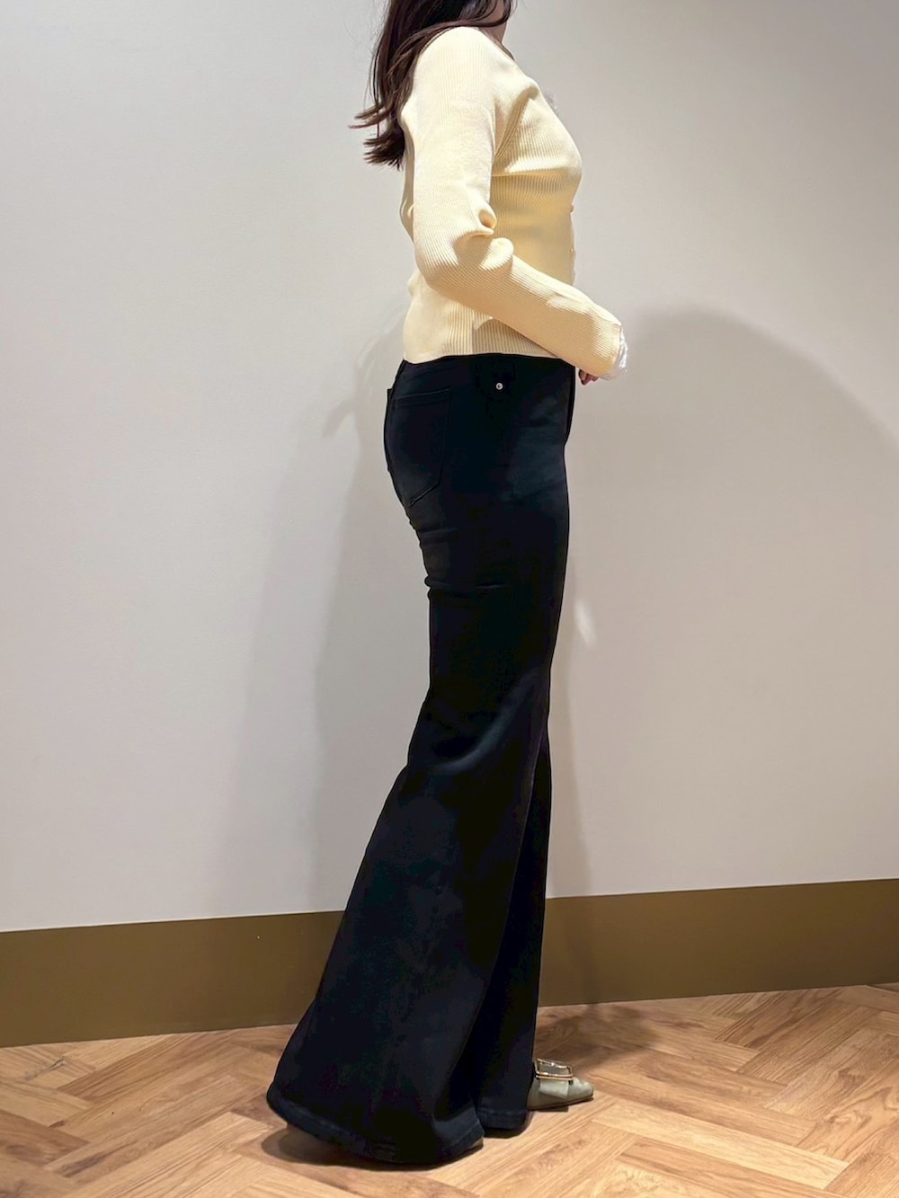 ホワイト系のニット/セーター、ブラック系のその他パンツを着用したレディースの春コーディネートの2枚目の写真