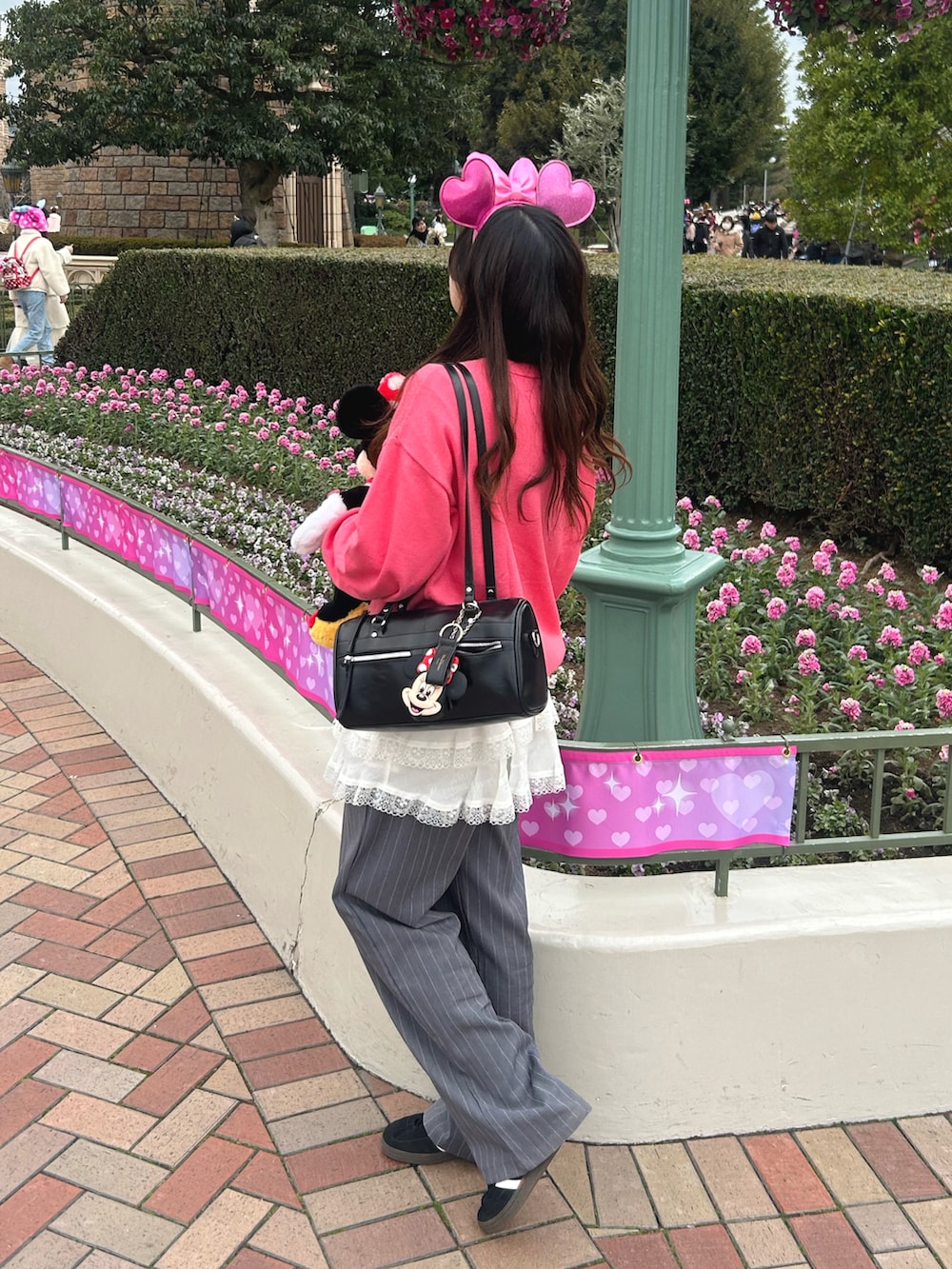 ピンク系のニット/セーター、ホワイト系のスカートを着用したレディースの冬コーディネートの3枚目の写真