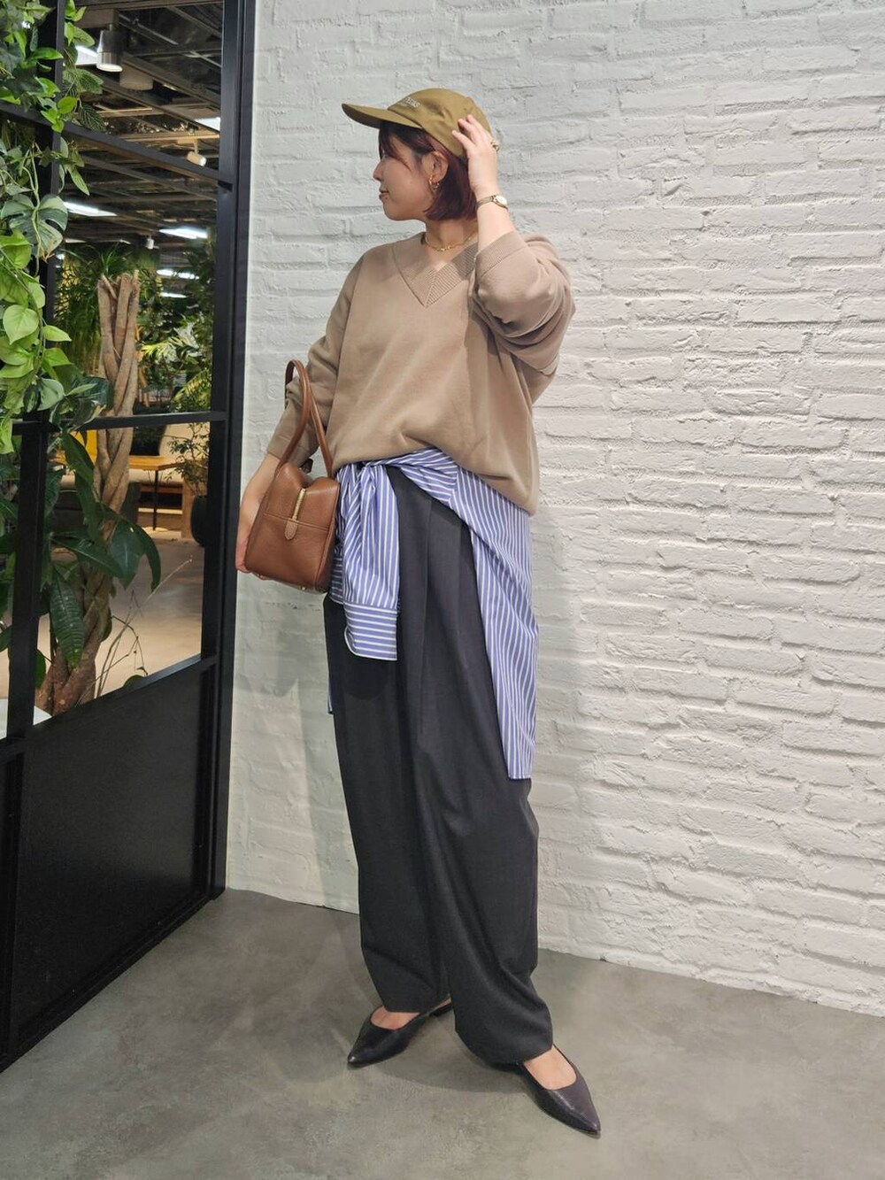 グレー系のその他パンツ、ブラウン系のハンドバッグ、ベージュ系のスウェットを着用したレディースの秋コーディネートの5枚目の写真