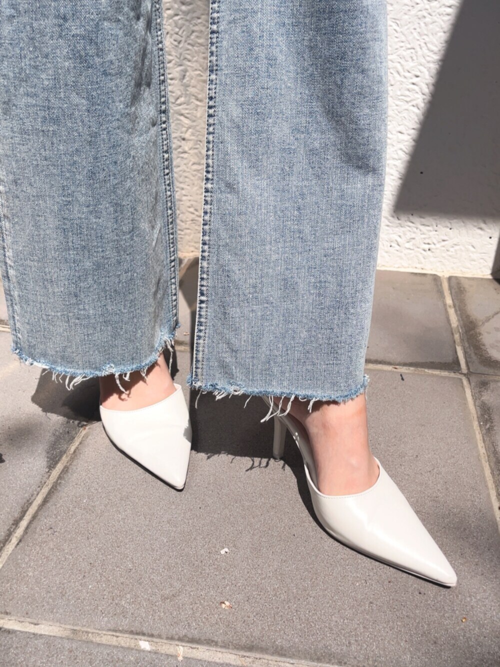 ホワイト系のパンプス、ブルー系のデニムパンツ、ホワイト系のTシャツ/カットソーを着用したレディースの春コーディネートの4枚目の写真