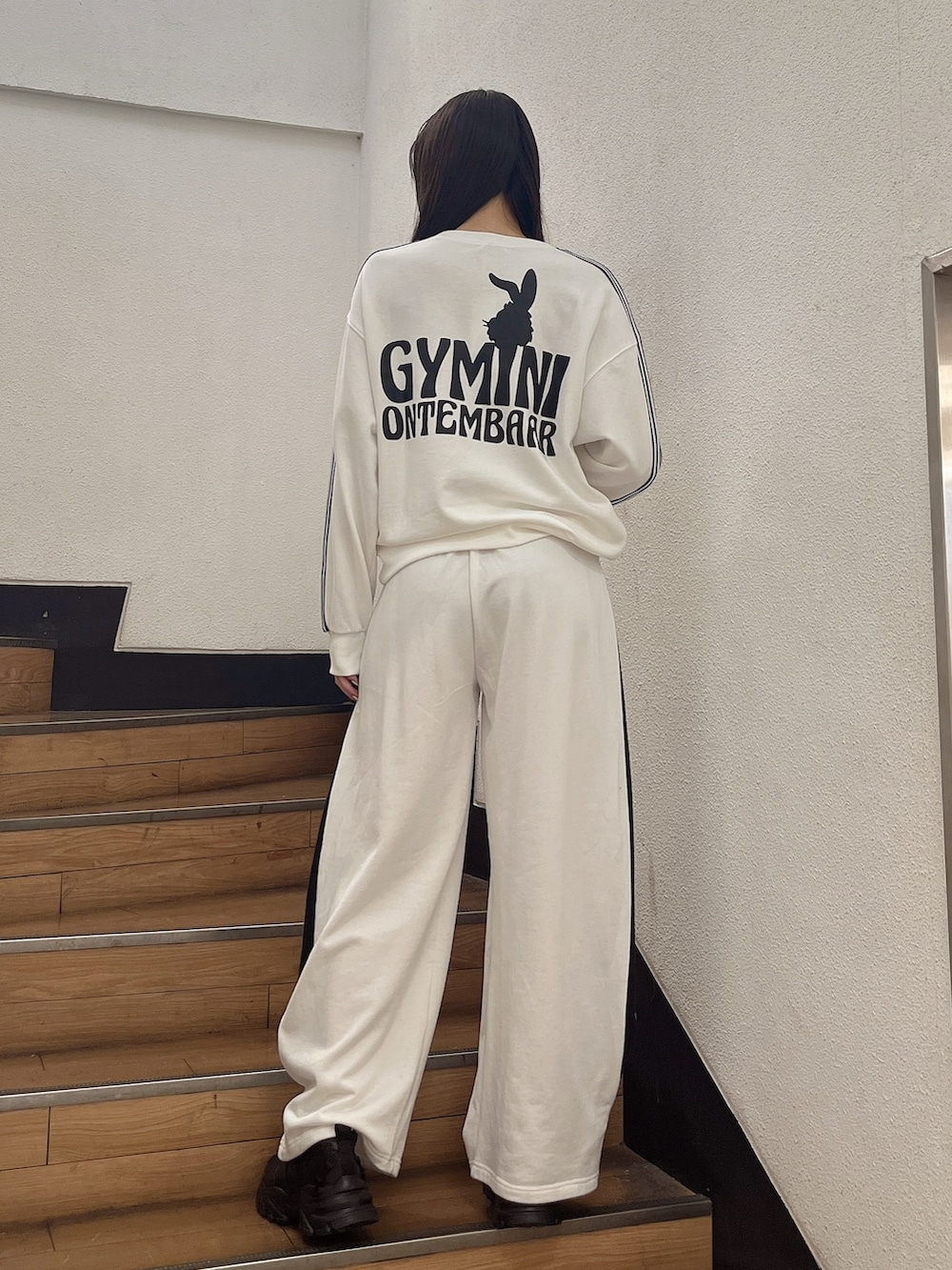 ホワイト系のスウェット、ホワイト系のスウェットパンツ、ブラック系のスニーカーを着用したレディースの冬コーディネートの3枚目の写真