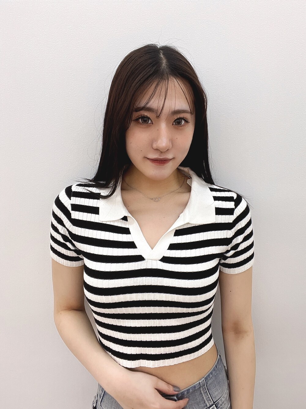 ブルー系のデニムパンツ、ホワイト系のパンプス、その他のニット/セーターを着用したレディースの春コーディネートの6枚目の写真