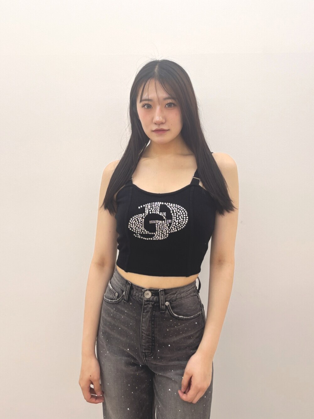 ブラック系のサンダル、ブラック系のキャミソール、ブラック系のデニムパンツを着用したレディースの夏コーディネートの7枚目の写真