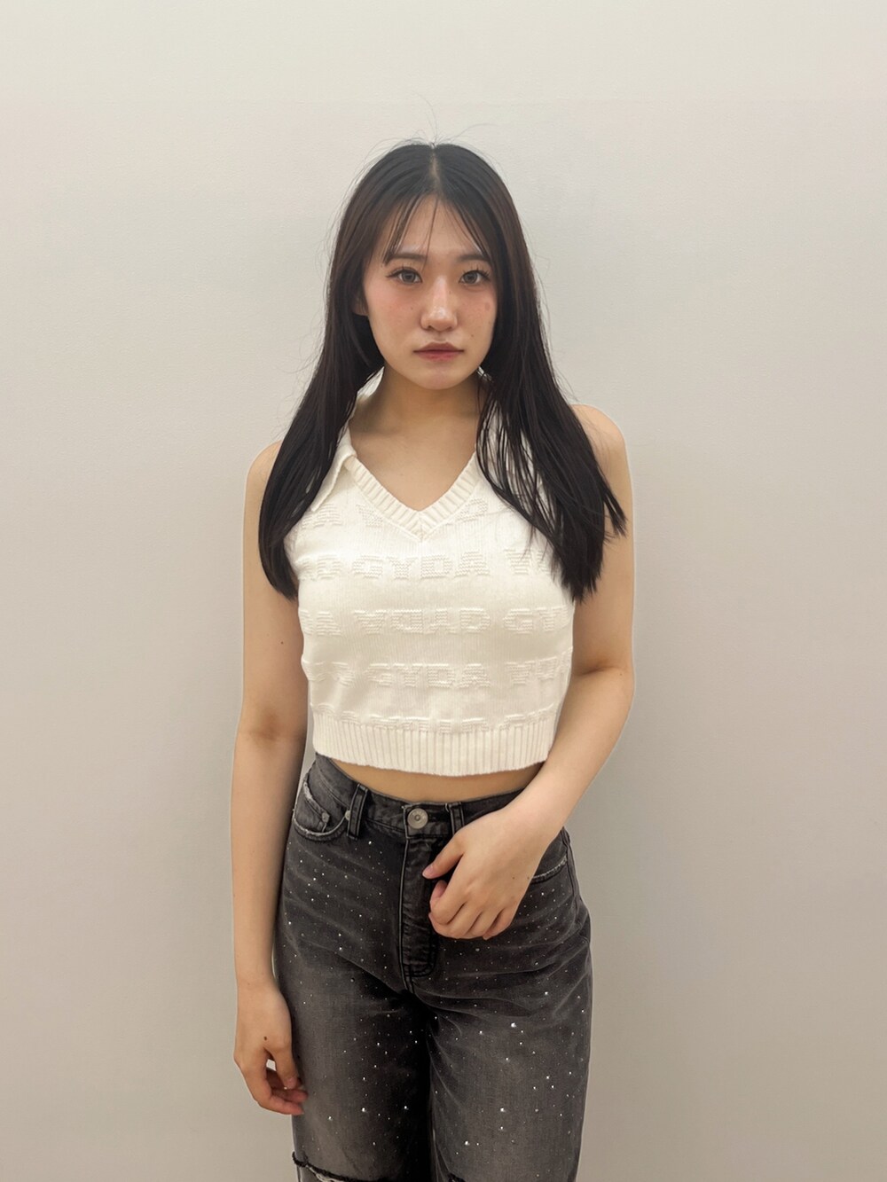 ブラック系のデニムパンツ、ホワイト系のニット/セーター、ホワイト系のサンダルを着用したレディースの夏コーディネートの7枚目の写真