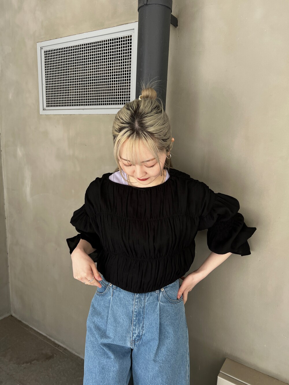 ブルー系のデニムパンツ、ブラック系のサンダル、パープル系のニット/セーターを着用したレディースの春コーディネートの3枚目の写真