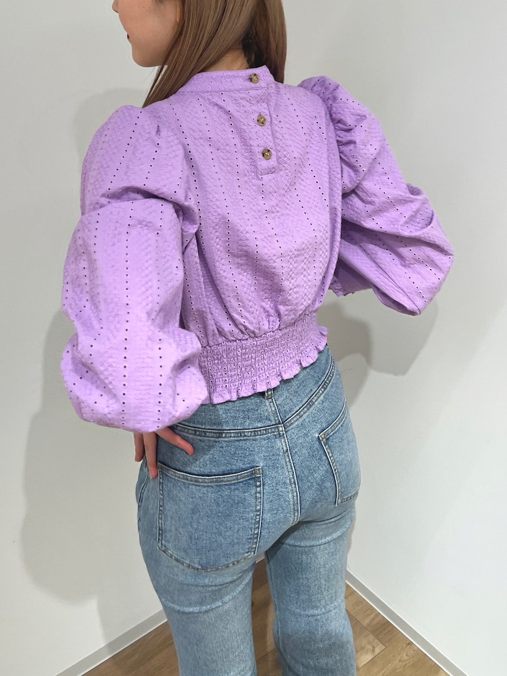 パープル系のシャツ/ブラウス、ブルー系のデニムパンツ、ホワイト系のブーツを着用したレディースの冬コーディネートの3枚目の写真