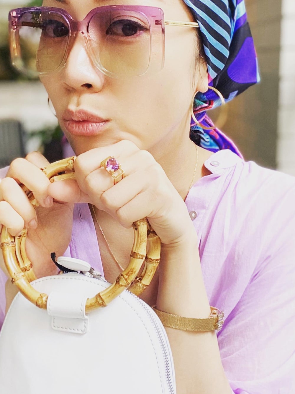 パープル系のシャツワンピース、ホワイト系のバッグ、ホワイト系のパンツを着用したレディースの秋コーディネートの3枚目の写真