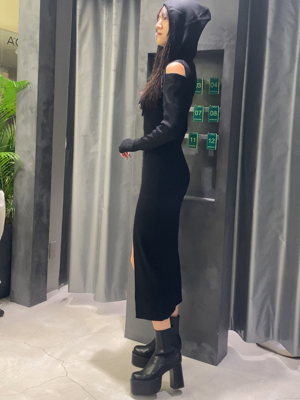 ブラック系のワンピース、ブラック系のブーツを着用したレディースの秋コーディネートの3枚目の写真