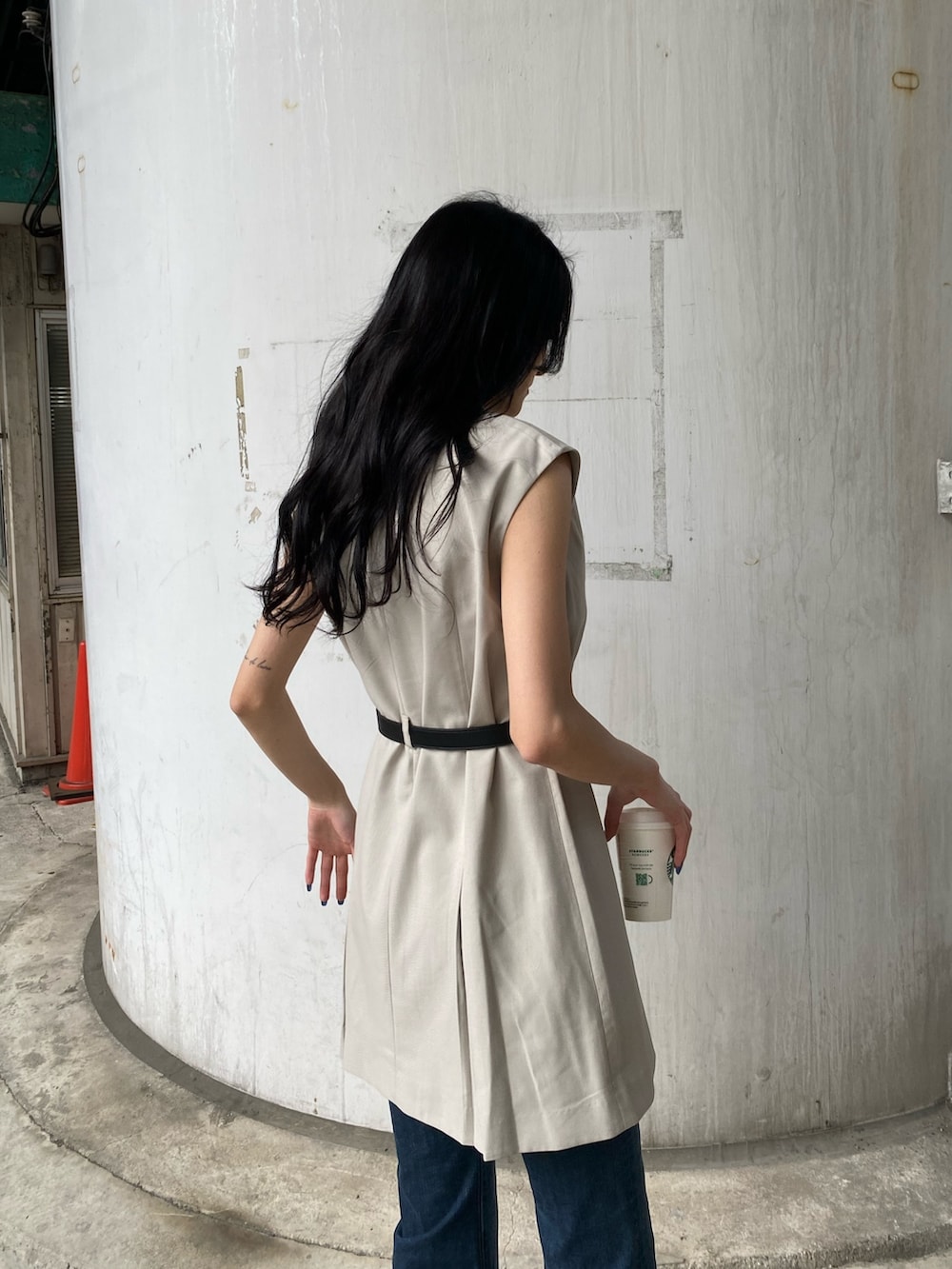 ホワイト系のワンピース、ブルー系のデニムパンツ、ブラック系のサンダルを着用したレディースの春コーディネートの7枚目の写真