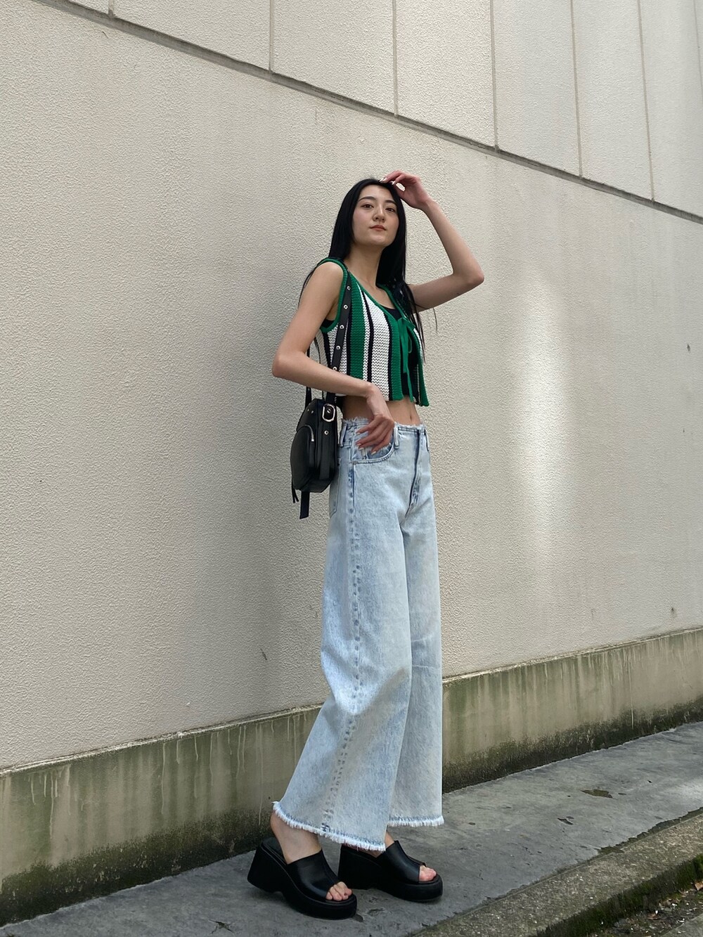 ブラック系のニット/セーター、その他のニット/セーター、ブルー系のデニムパンツを着用したレディースの春コーディネートの2枚目の写真