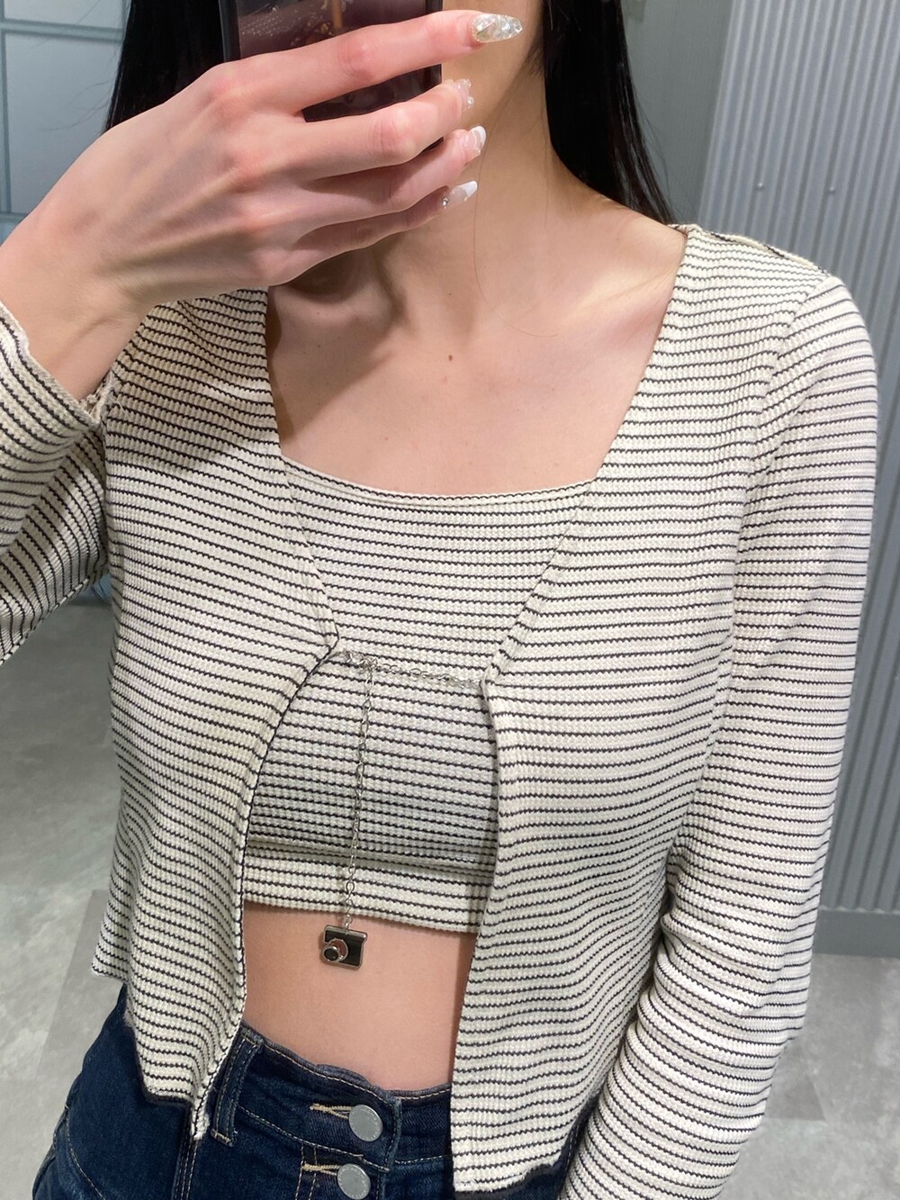 ブラック系のブーツ、ブルー系のデニムパンツ、その他のTシャツ/カットソーを着用したレディースの春コーディネートの9枚目の写真