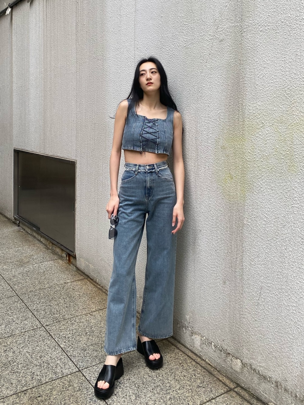 ブルー系のデニムパンツ、ブルー系のその他トップス、ブラック系のサンダルを着用したレディースの春コーディネートの3枚目の写真