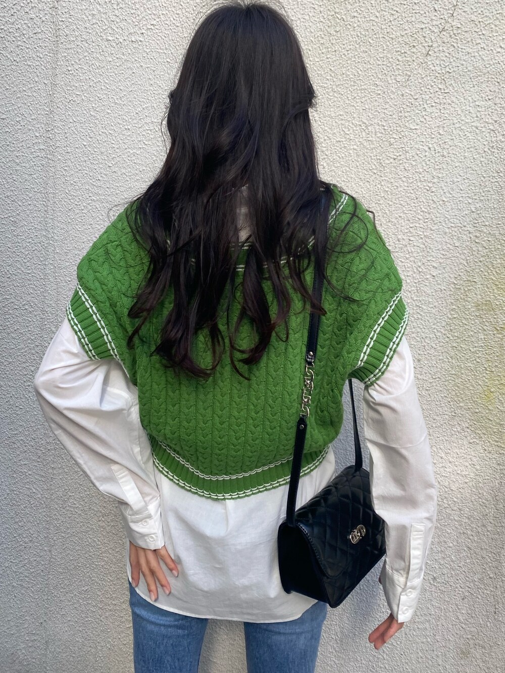 グリーン系のベスト、ホワイト系のシャツ/ブラウス、ブラック系のショルダーバッグを着用したレディースの冬コーディネートの8枚目の写真