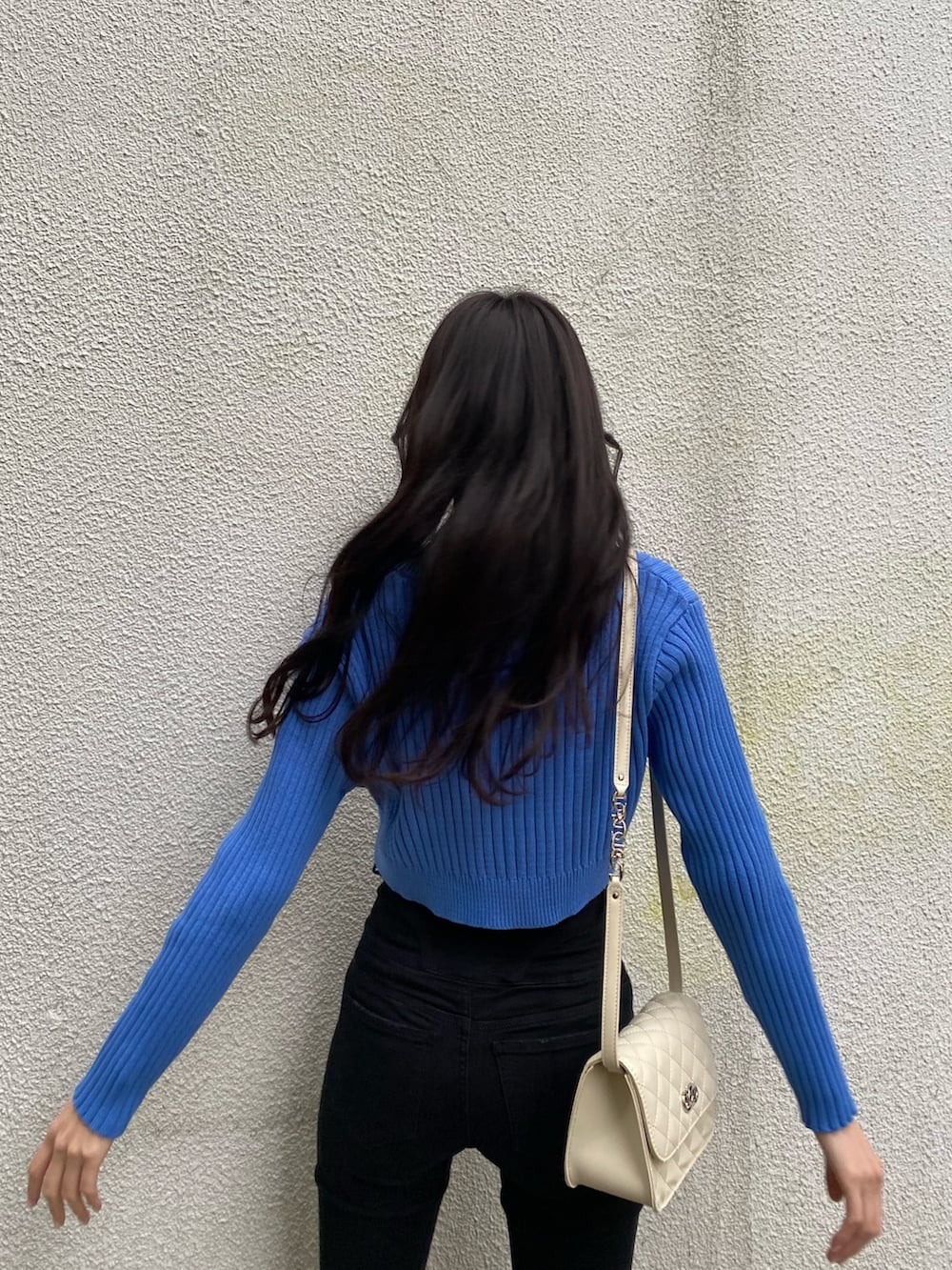 ブルー系のカーディガン/ボレロ、ブラック系のデニムパンツ、ブラック系のブーツを着用したレディースの冬コーディネートの6枚目の写真