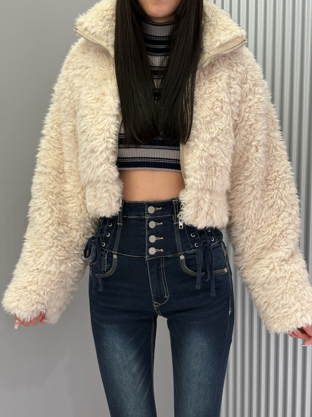 ブルー系のデニムパンツ、ホワイト系のブルゾン、グレー系のニット/セーターを着用したレディースの秋コーディネートの5枚目の写真