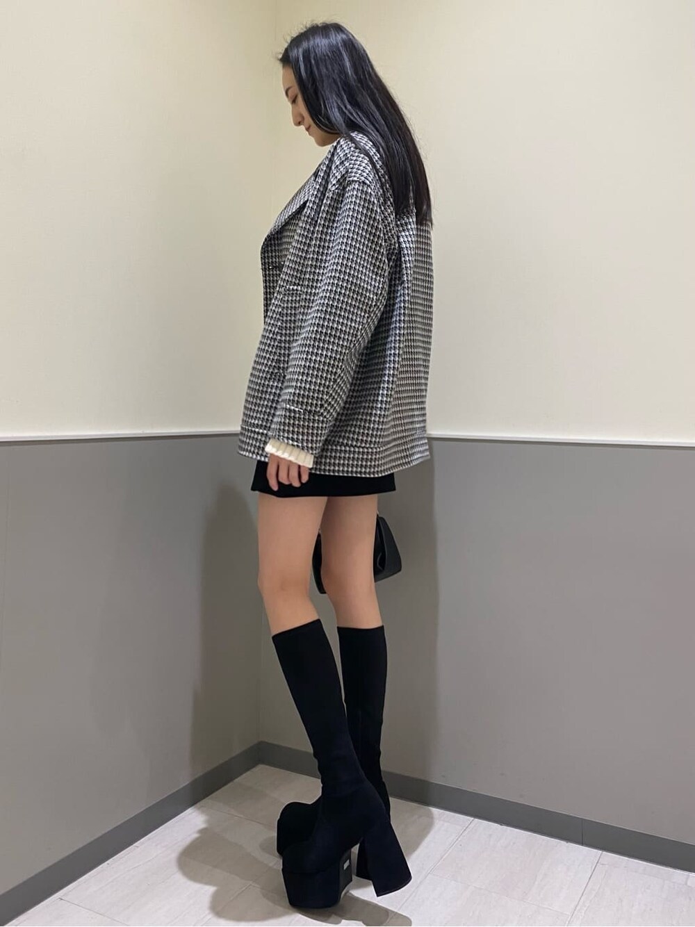 ブラック系のブーツ、その他のテーラードジャケット、ブラック系のスカートを着用したレディースの秋コーディネートの3枚目の写真