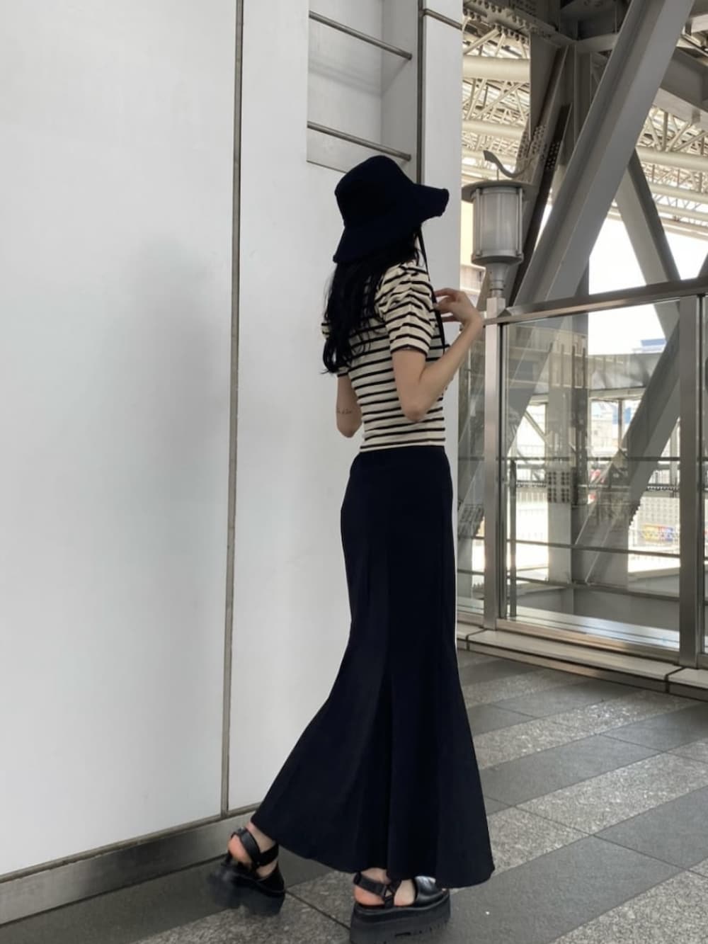 ブラック系のサンダル、ブラック系のスカート、その他のTシャツ/カットソーを着用したレディースの夏コーディネートの2枚目の写真